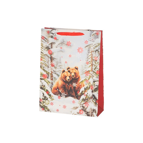 Jouluisessa lahjakassissa kuvana karhupariskunta lumisessa metsämaisemassa