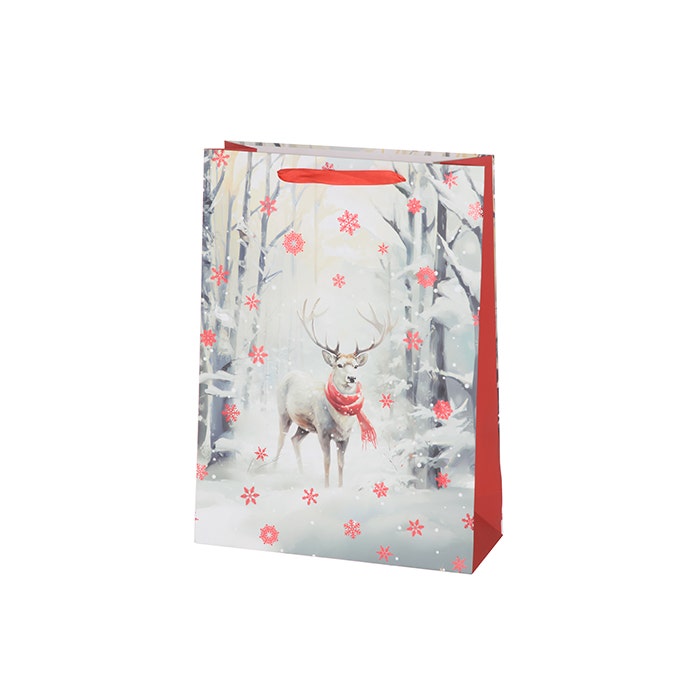 Jouluisessa lahjakassissa kuva porosta lumisessa metsämaisemassa